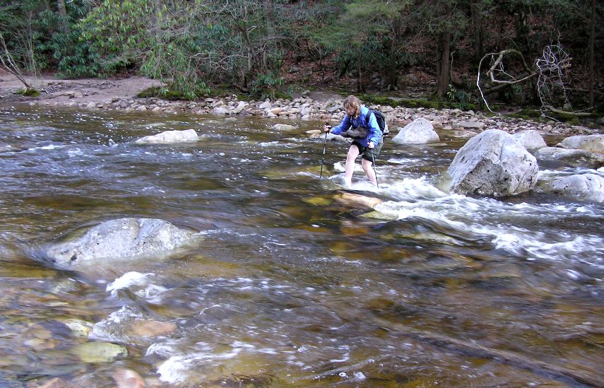 Norma doing stream crossing with hiking poles