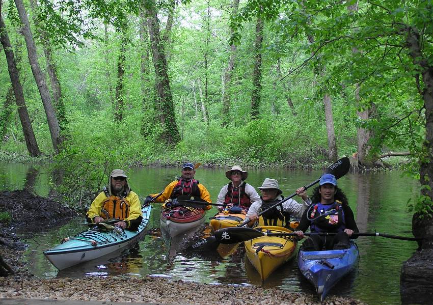 Five male kayakers in their boats at the Tuckahoe Campground Area Launch Site