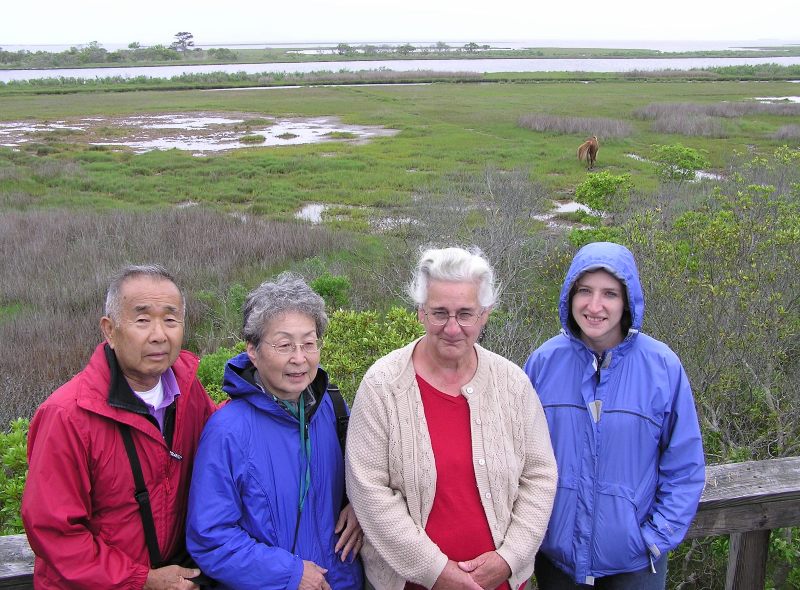 Dad, Mom, Hazel, and Norma with pony in the background and water behind it