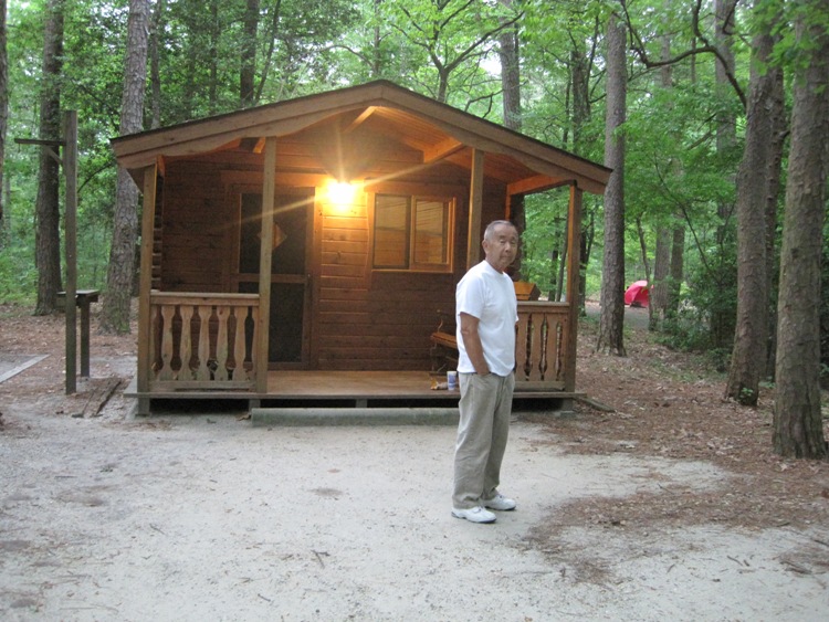 Dad standing in front of mini-cabin