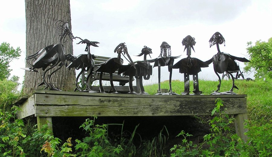 Metal sculptures of cartoonish birds on pier