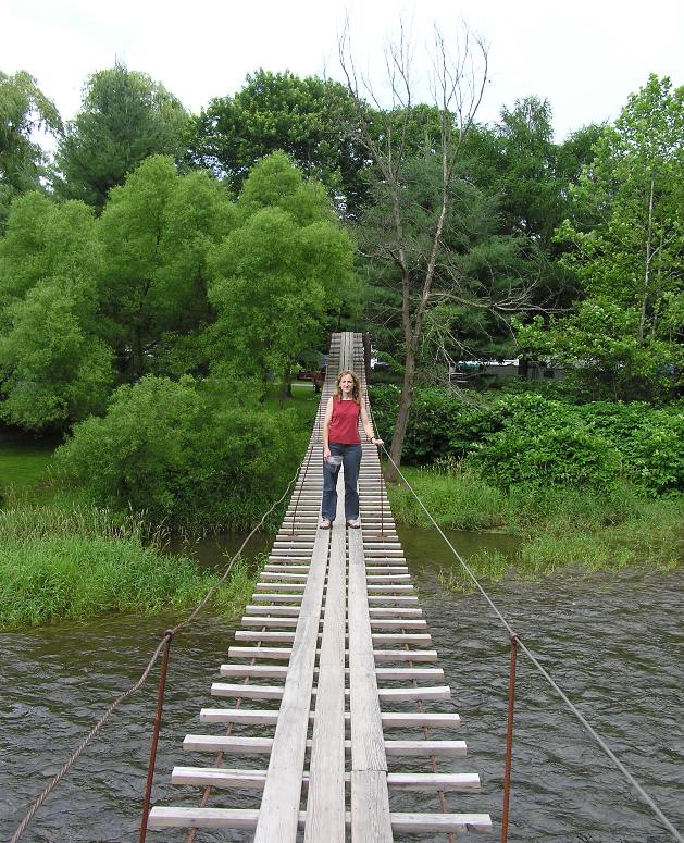 Norma standing on swinging bridge