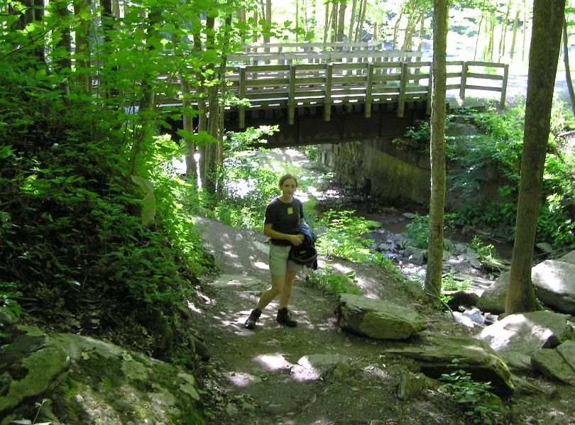 Norma on Turkey Path with a wooden bridge behind