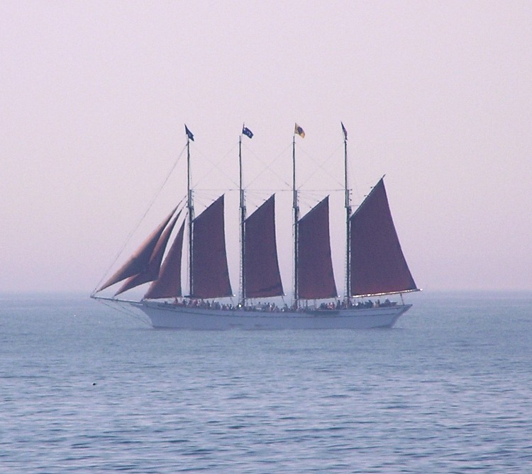 Sailing ship with seven sails and lots of passengers