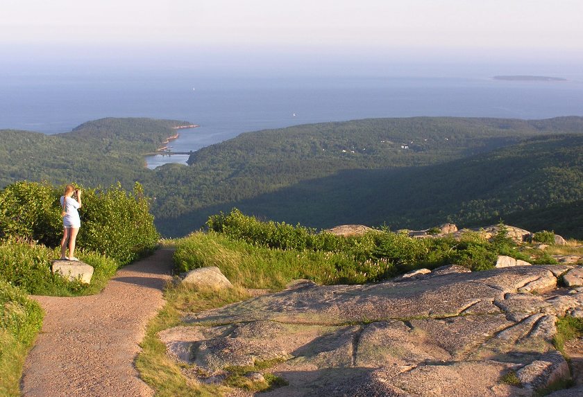 Woman standing, looking at Frenchman Bay in the distance