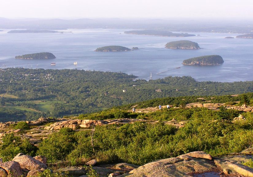 Porcupine Islands with some boats around them, including the one with the red sails