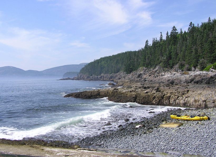 Our kayak on a rocky beach with crashing waves nearby