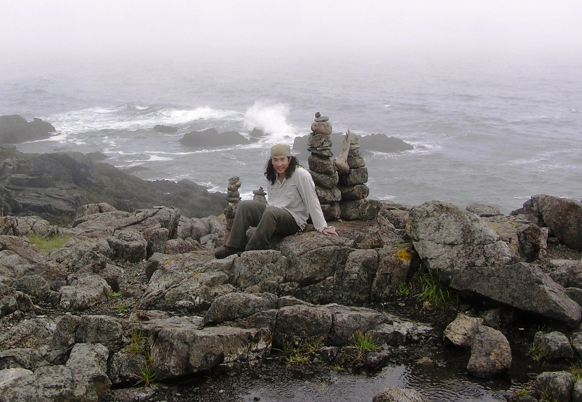 Me sitting in rocky field full of cairns