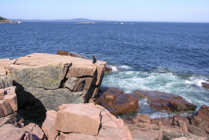 Me sitting on the rocks with the water behind