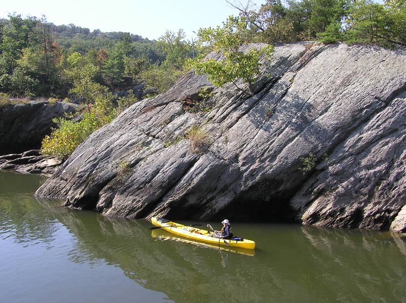 Norma in the tandem kayak with big boulder behind