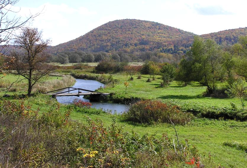 Marsh Creek with bridge and hill in background