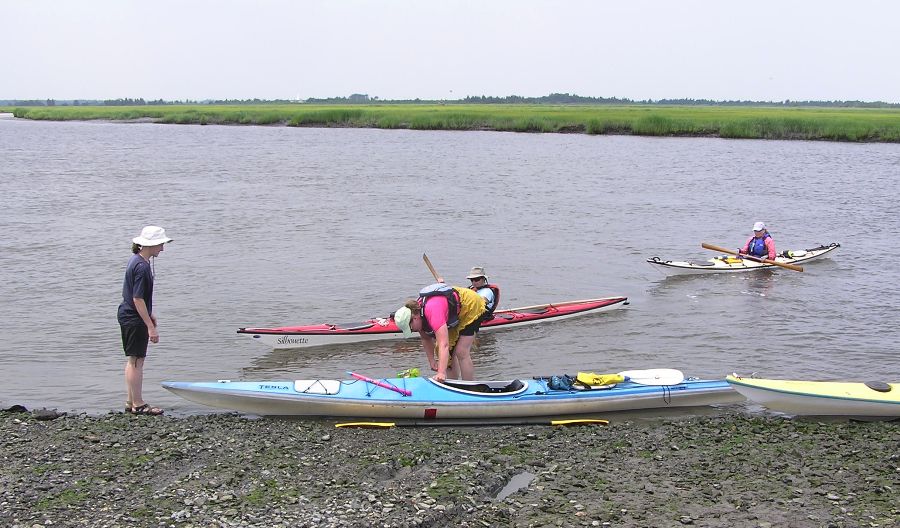 Norma stands by ready to lend a hand while Lisa F. gets out of her kayak named after a 1980s big hair metal band from Sacramento