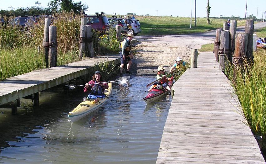 Boat ramp with Dave paddling forward in his yellow kayak