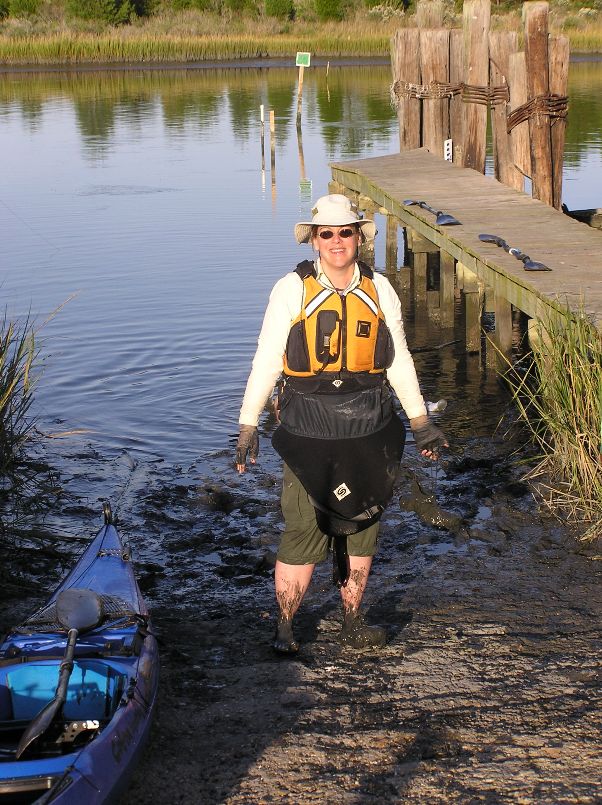 Suzanne with the lower part of her body covered in mud