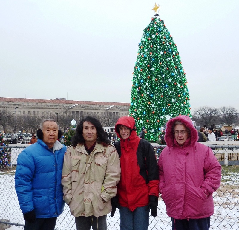 Dad, me, Joyce, and Hazel in front of Christmas tree