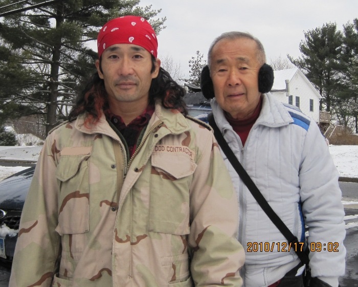 Dad and I in the front yard with him wear earmuffs