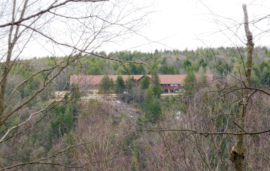 Blackwater Lodge and Conference Center on the side of a hill with lots of trees