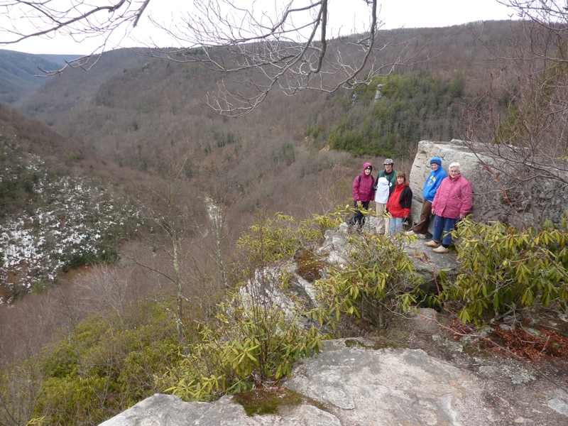 Our group minus me standing on some rocks with the river below