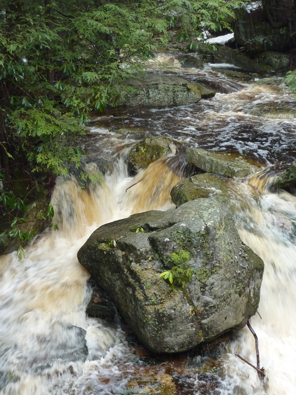 Brown water flowing into the falls