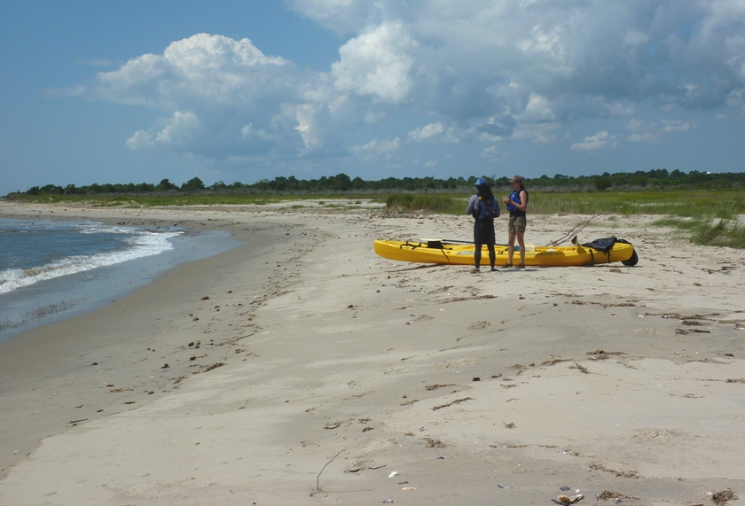 Carmen and I standing on the beach next to their kayak