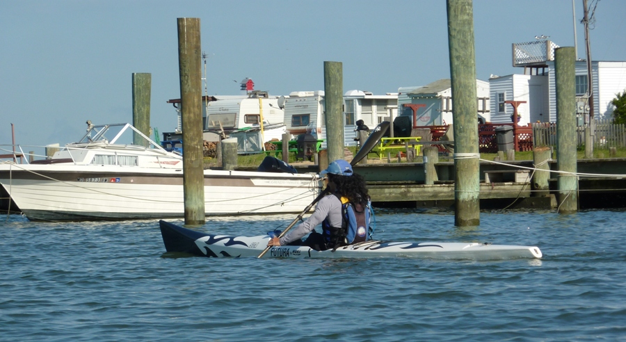 Me on surf ski paddling near piles