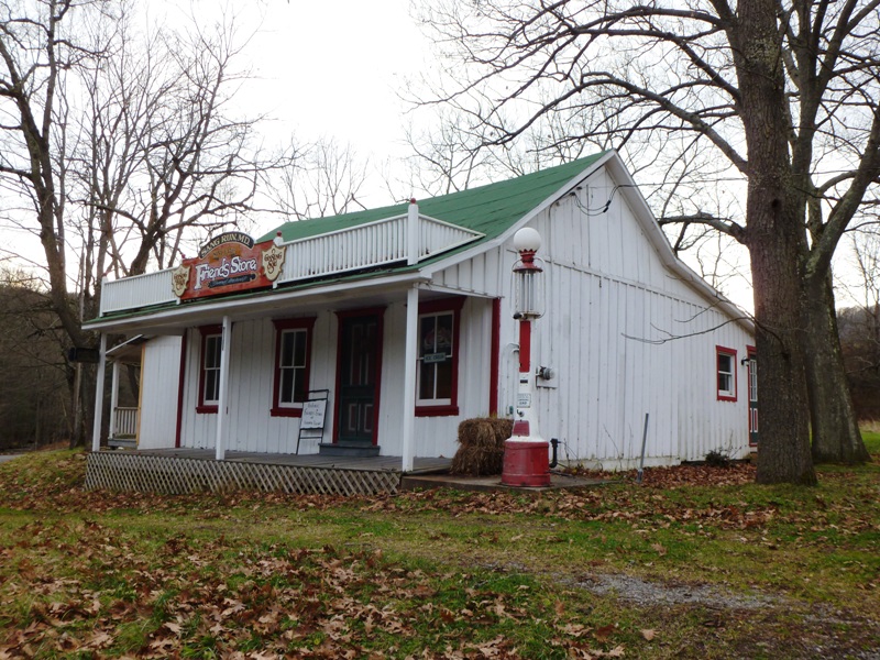 White painted Friends Store with old gas pump