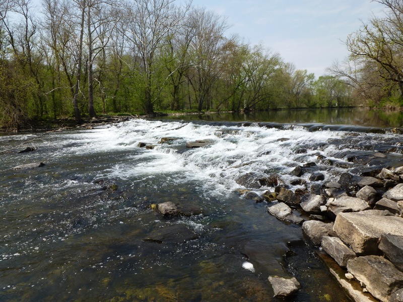 Looking upstream at water flowing over dam