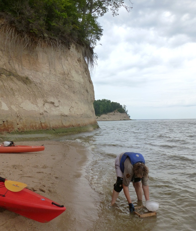 Kayak and person sifting for fossils