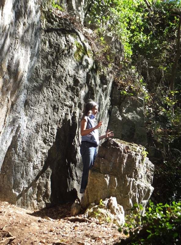 Carmen pretending to deliver a sermon at a rock podium