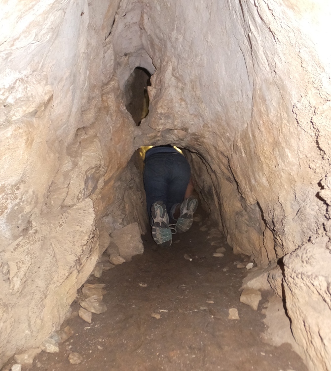 View of Carmen crawling deeper into the cave