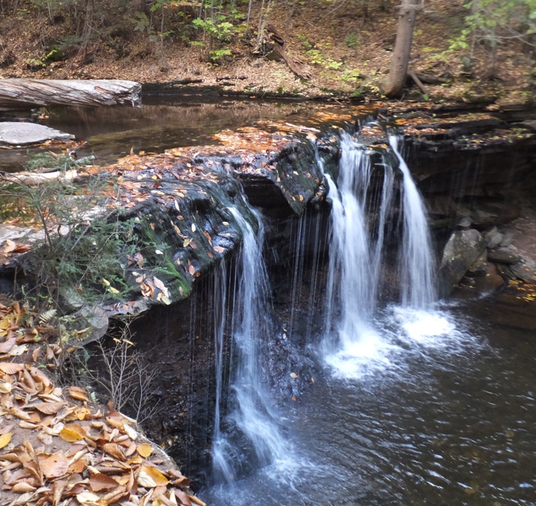 Diagonal view showing water above and below the falls