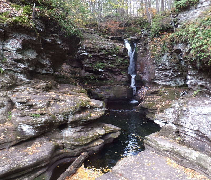 View of the falls through a narrow, rocky opening