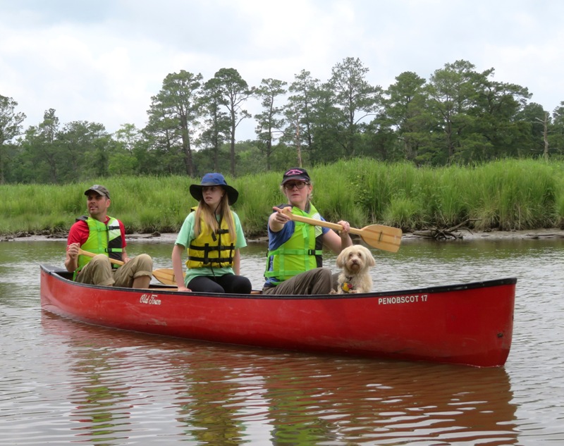 Allison pointing at something from inside the canoe