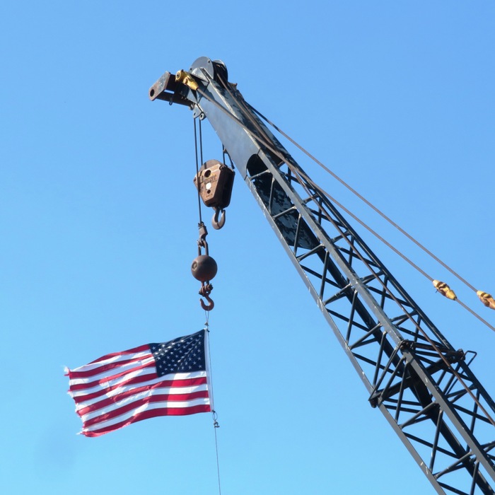 American flag hanging from crane