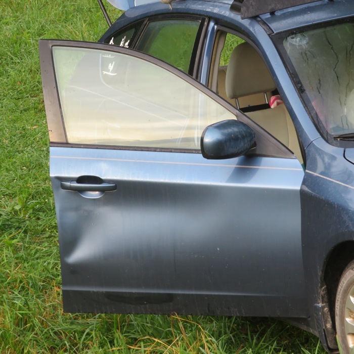 Dent in my passenger door from being kicked by a cow