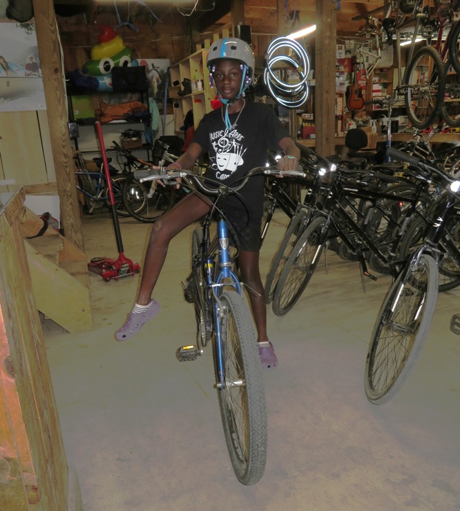 Second oldest kid on a bike in the shop