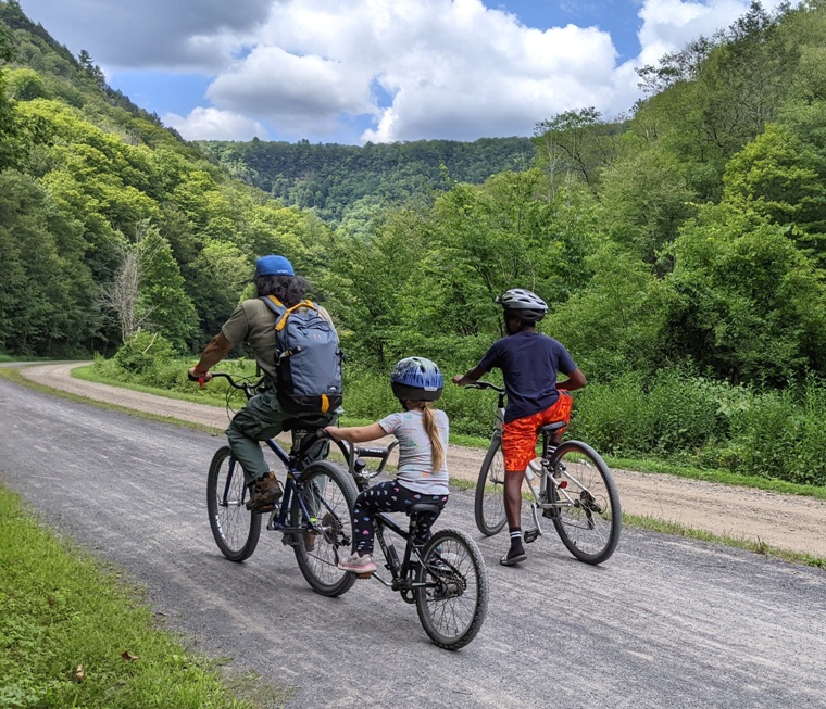 Me and two kids with the greenage of the valley in the background