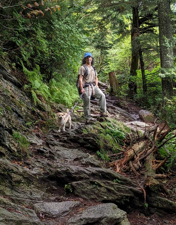 Daphe and I on a rocky trail in the woods, standing near ferns