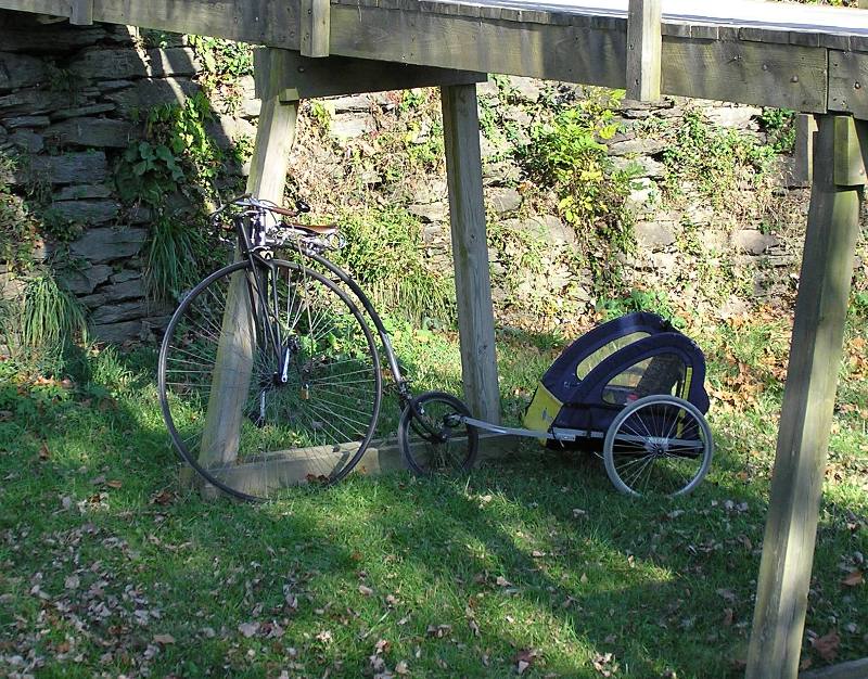 Modern version of old-fashioned bicycle with trailer in tow