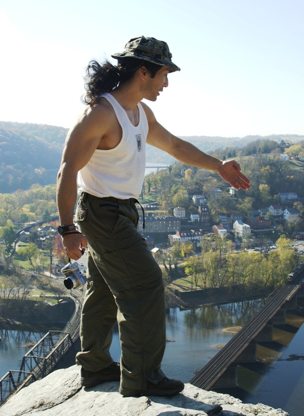 Me pointing down to something with Harpers Ferry in the background