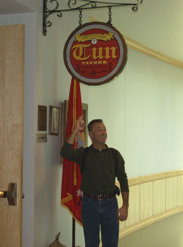 Mike pointing to Tun Tavern sign