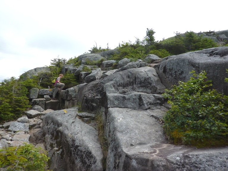 Norma climbing up big rocks