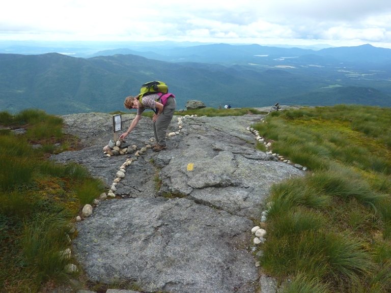 Norma putting a rock on a cairn