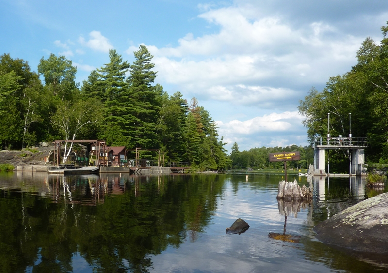 Waterway with lock on the left, canoe carry on the right.