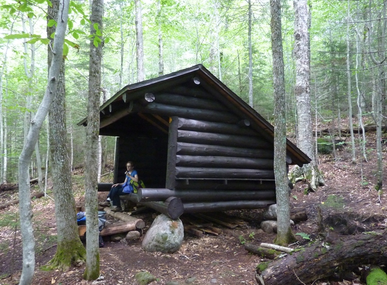 Norma eating a snack at a sturdy lean-to