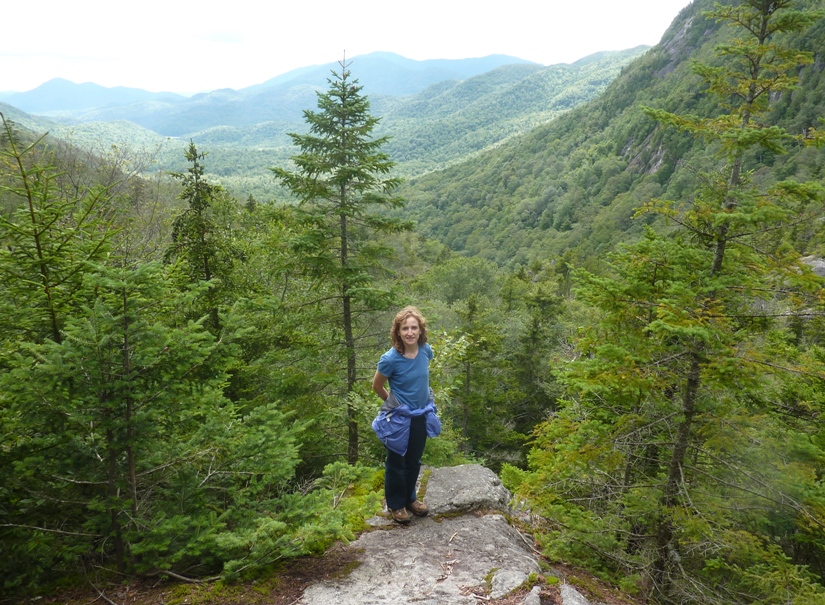 Norma standing on rock with scenic view behind