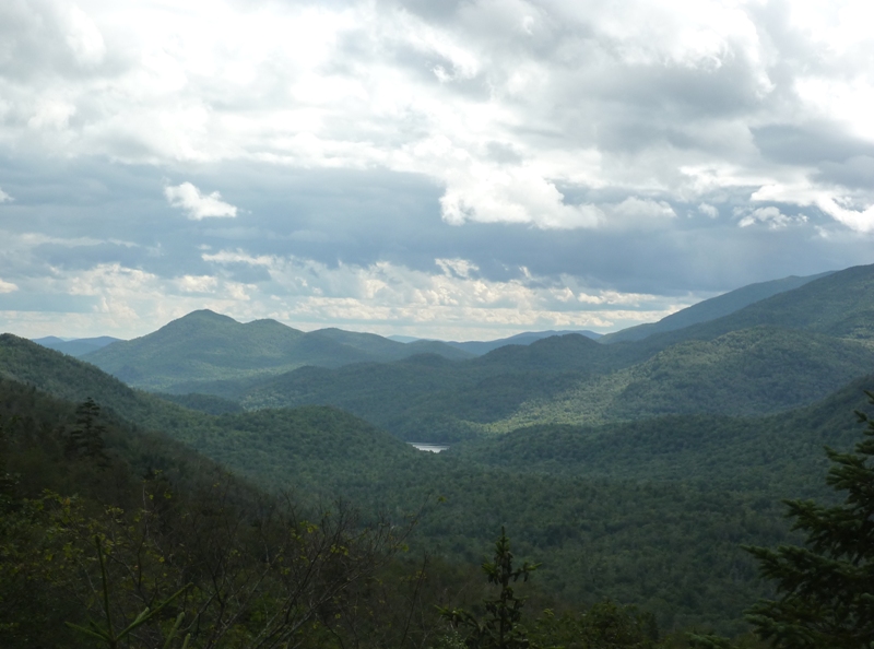 A small lakes between the mountains in the distance