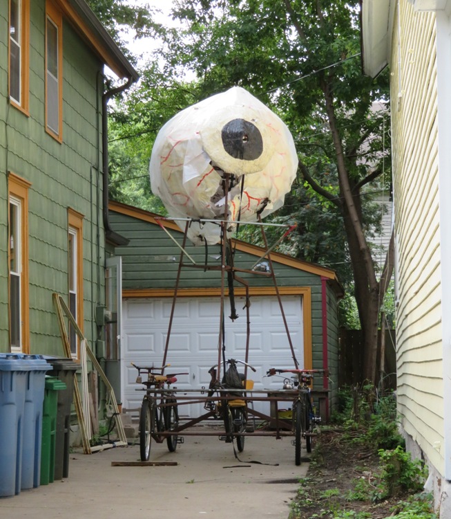 Giant eye mounted above at least three connected bicycles