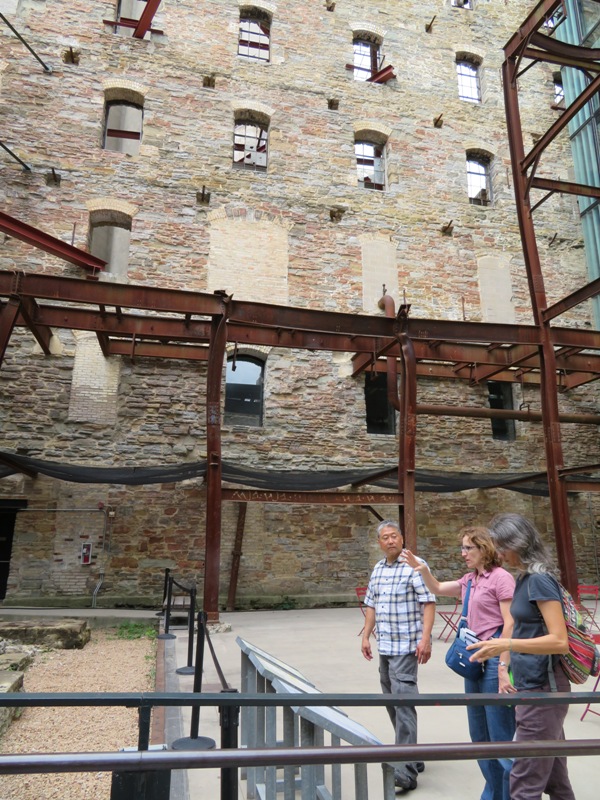 Steve, Norma, and Carmen in front of stone wall