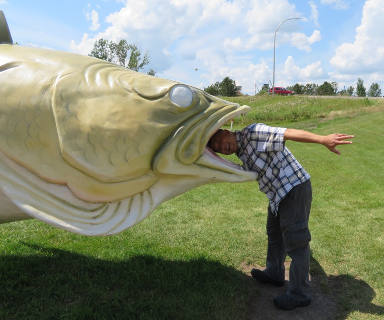 Steve putting his head in the fish statue